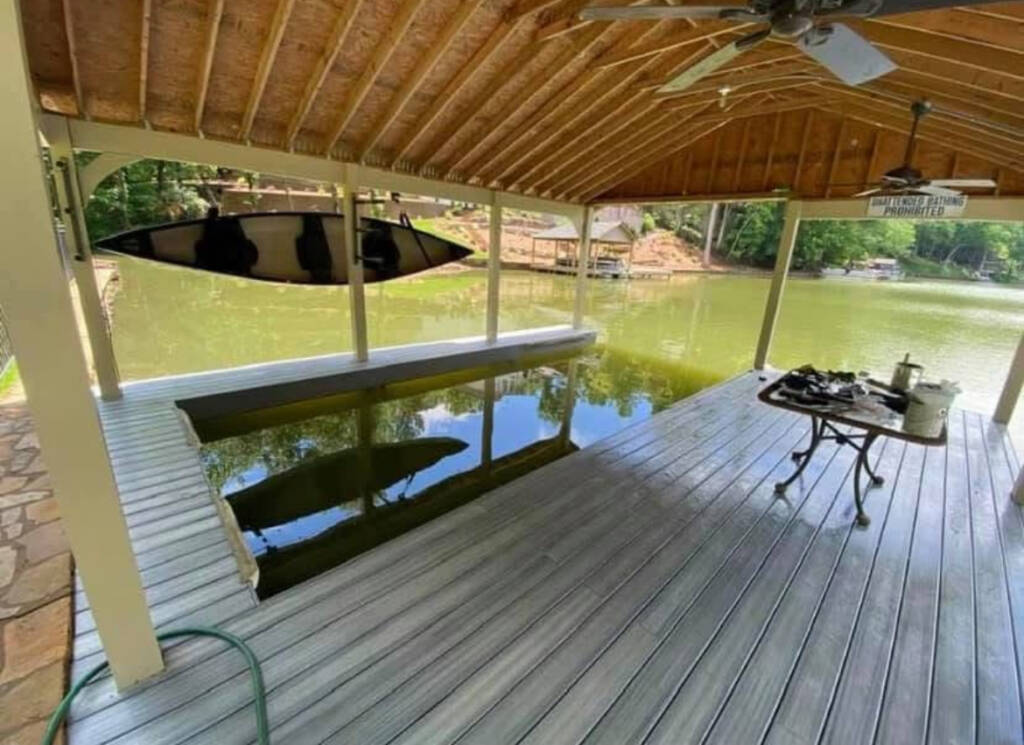 Covered lake dock with deck and boat lift