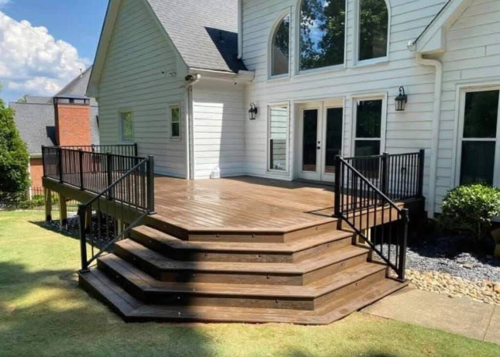 Multi-level wood deck with black metal railing at a Georgia home